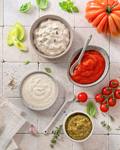 Various pizza sauces in small bowls